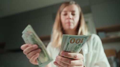 Woman Counting Money Indoors