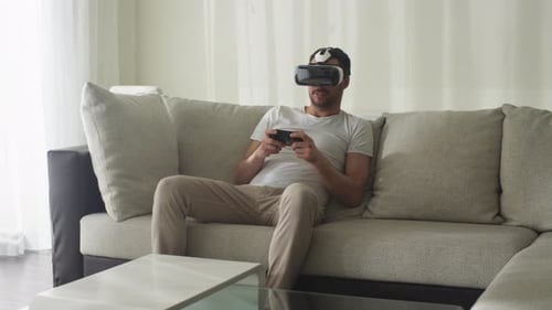 Man Experiencing Virtual Reality on Couch with VR Headset