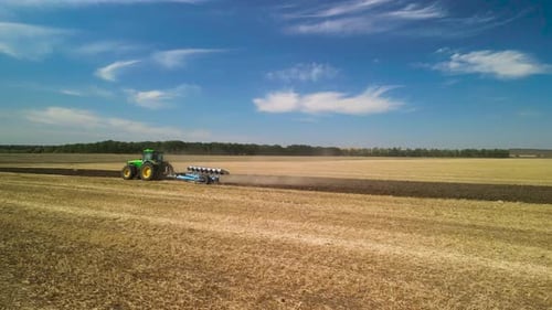 Tractors plowing the field in Ukraine