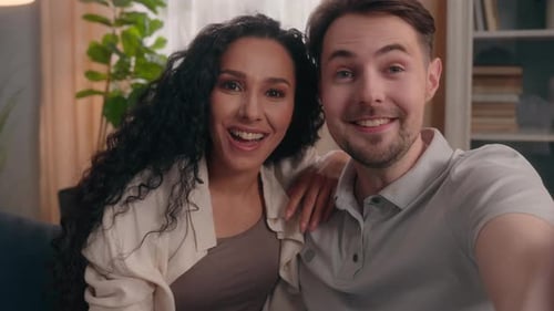 Smiling Caucasian Male Man with Hispanic Female Woman Talking Video Call Home Webcam View Happy