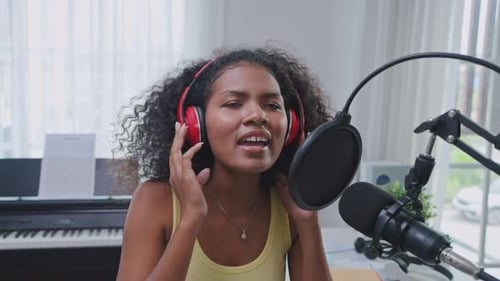 Diverse young stylish audio producer working in the music record studio.