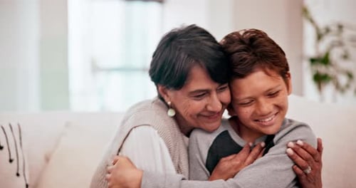 Loving Grandmother Hugging Grandchild on Sofa