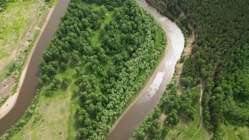 Aerial of Winding River Between Green Meadows and Forest Landscape with a Small Meandering River