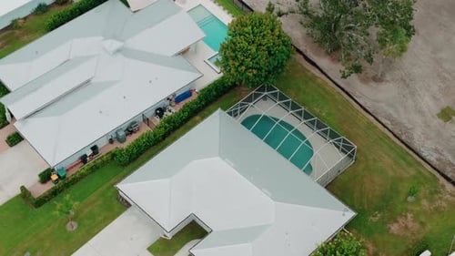 Drone Above View of Screened in Pool and Lanai in Florida Houses