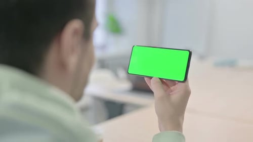 Young Man Watching Smartphone with Chroma Key