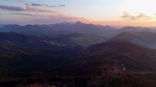 Aerial Drone View of Carpathian Forest Hilly Wooded Landscape at Twilight Sky Lit By Sunset