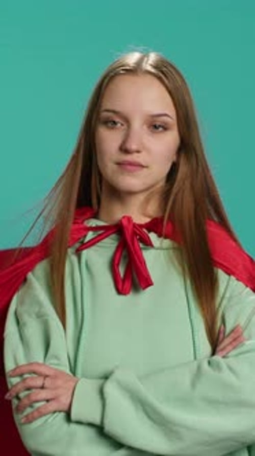 Vertical Video Happy Young Girl Portraying Superhero Flying with Cape Fluttering in Wind