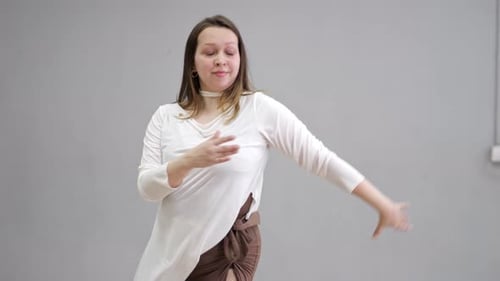 Woman Dancing Gracefully in a Studio