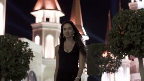 Beautiful Girl in the Background of a Night City in Slow Motion