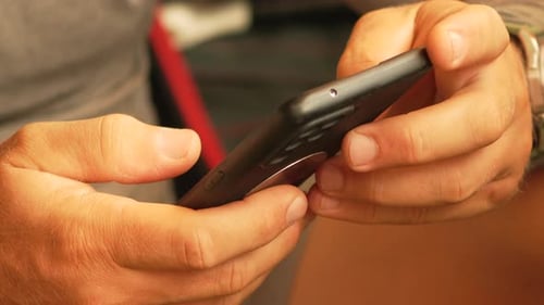 Closeup of Hands Holding a Smartphone