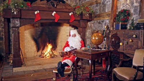 Santa Claus Reading by the Christmas Fireplace