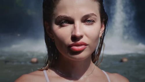 Beautiful Girl in a Waterfall Wet Hair Face of a Sexy Woman Female is on Vacation Tropical Place