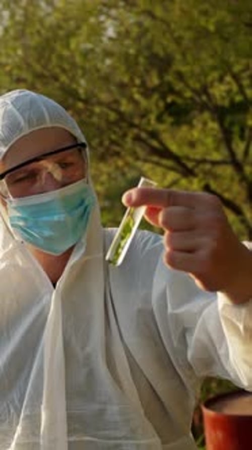 Scientist Examining Green Liquid in a Test Tube