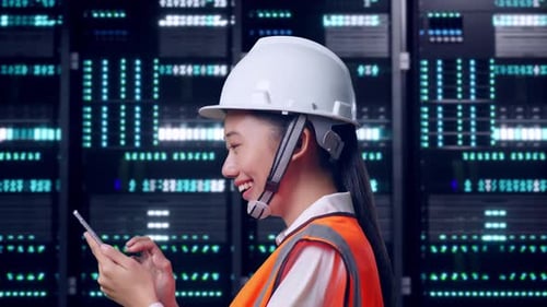 Asian Female Use Smartphone While Walking in Data Center
