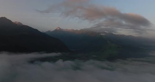 Misty Clouds Across Mountain Landscape