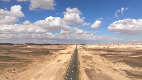 Empty Desert highway mountain road with Blue cloudy sky