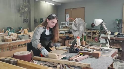 Young female carpenter working in a workshop