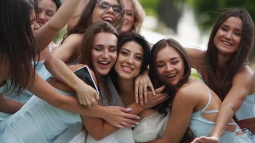 Pretty Bridemaids in Identical Blue Dresses Run to Hug Bride Together in Park Cheering Waving Hands