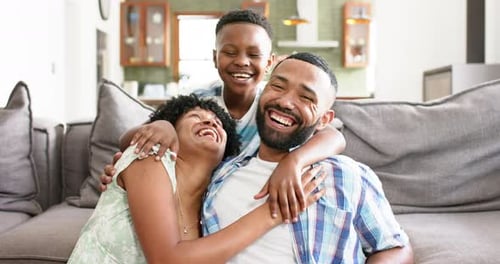 Joyful Family Embracing on Couch at Home