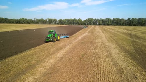 Tractors plowing the field in Ukraine