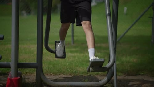 Engaging in Outdoor Workouts Using Fitness Equipment Available in the Park Environment