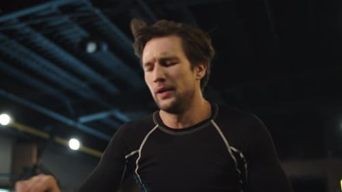 Closeup Exhausted Bodybuilding Man Training in Sport Club. Portrait of Tired Fitness