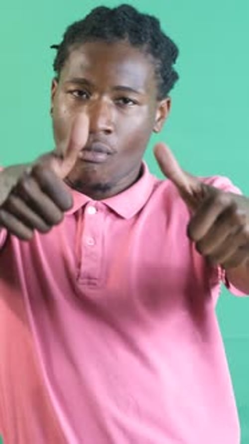 Young Adult Gives Thumbs Up on Green Screen