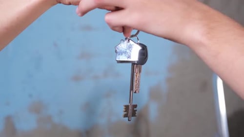 Own Home Mortgage Relocation Concept Couple Hands Holding Key From New First House Family