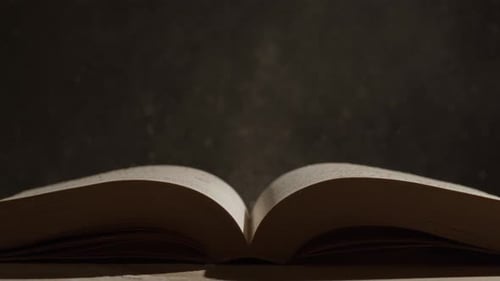 Open Book with Dust Particles in Dim Light