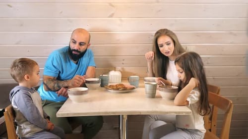Family Enjoys Meal at Home Together