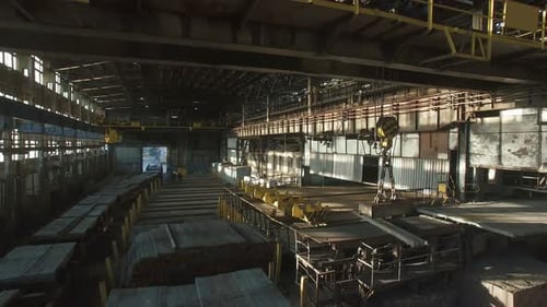 Aerial Shot Inside Big Industrial Building With Moving Electromagnetic Cranes.