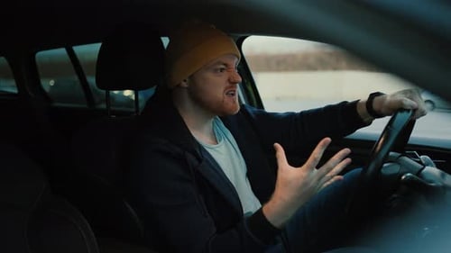 Frustrated Man Driver Showing Fingers During Road Trip in Car