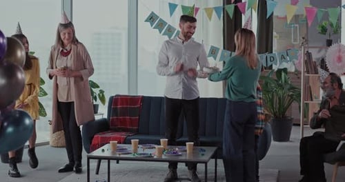 Adult Receives Birthday Cake With Family and Friends