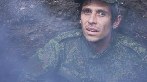 Worried Soldier in Camouflage Puts Hands on Head