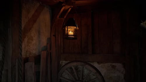 Flickering Candle Lantern in Dark Rustic Wooden Interior