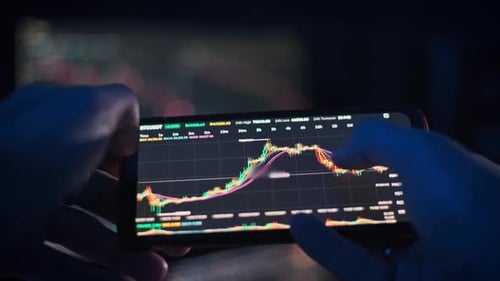 Person Analyzing Cryptocurrency Graph on Smartphone