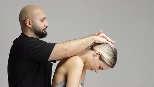 Therapist Performing Gentle Cervical Neck Stretch and Manual Alignment on Client During