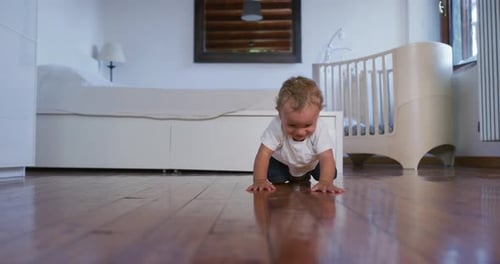 Happy Infant Crawling on a Hardwood Floor