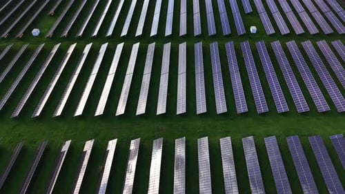 Aerial View of Solar Panel Field on Green Grass