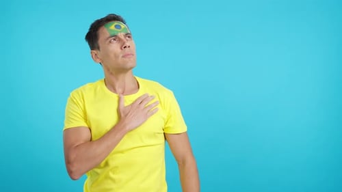 Man Holding Hand to Heart with Flag Sticker