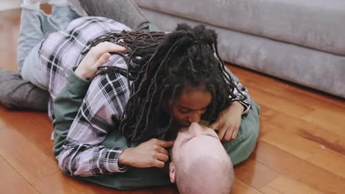 Loving Couple Lying on Floor at Home