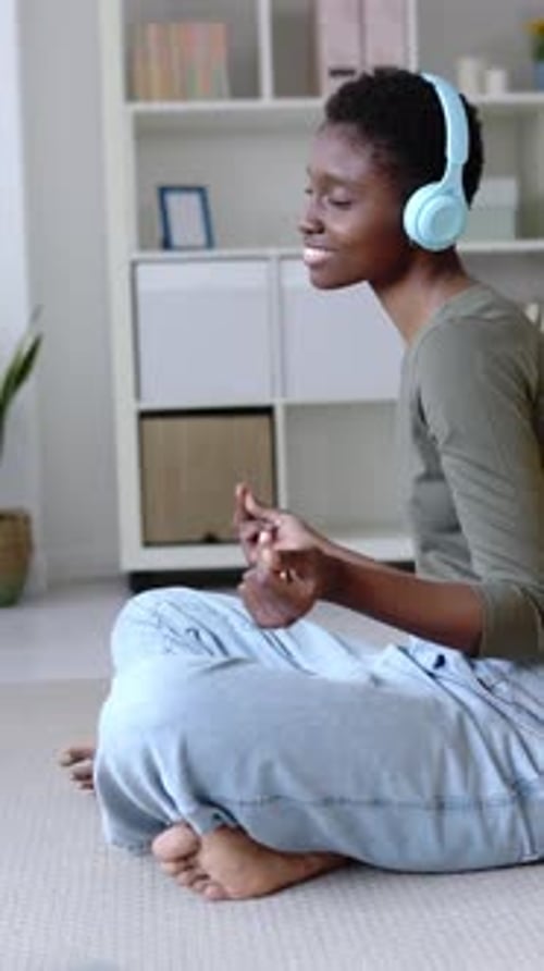 Woman Listening to Music with Headphones Indoors