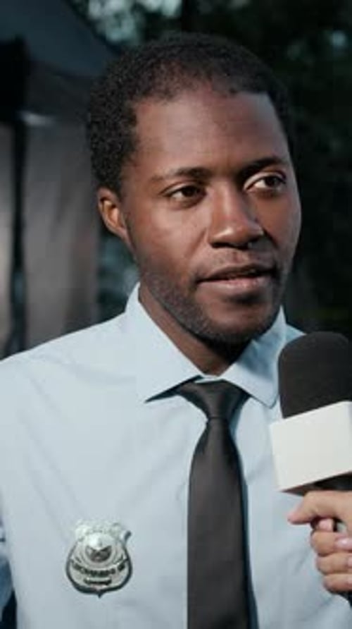 Police Officer Gives News Interview in Uniform