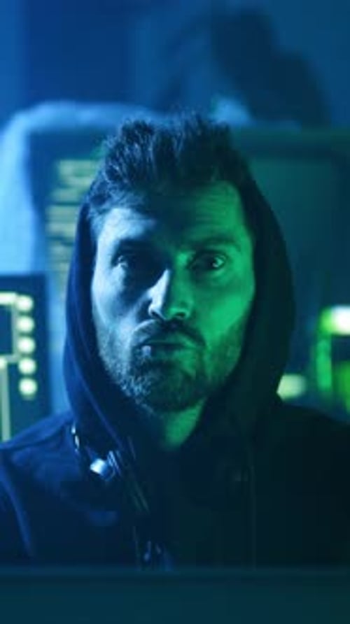 Person In Hoodie With Blue And Green Lighting