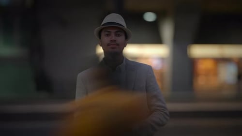Man Standing Out of the Crowd Watching People Commuting