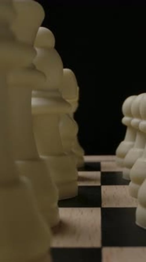 A Detailed View of Chess Pieces Positioned on a Chessboard Showcasing a Strategic Game Setup