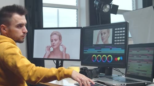 Freelance Videographer Colorist Editing Footage Using Professional Software Monitor and Montage