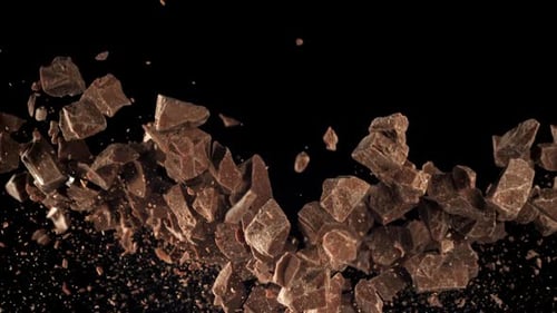Chocolate Chunks Tumbling on a Black Background