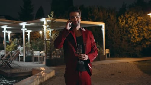 Stylish Man Talking on Phone at Night
