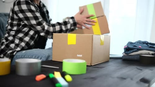 Girl Packing Packing A Cardboard Box For Shipping